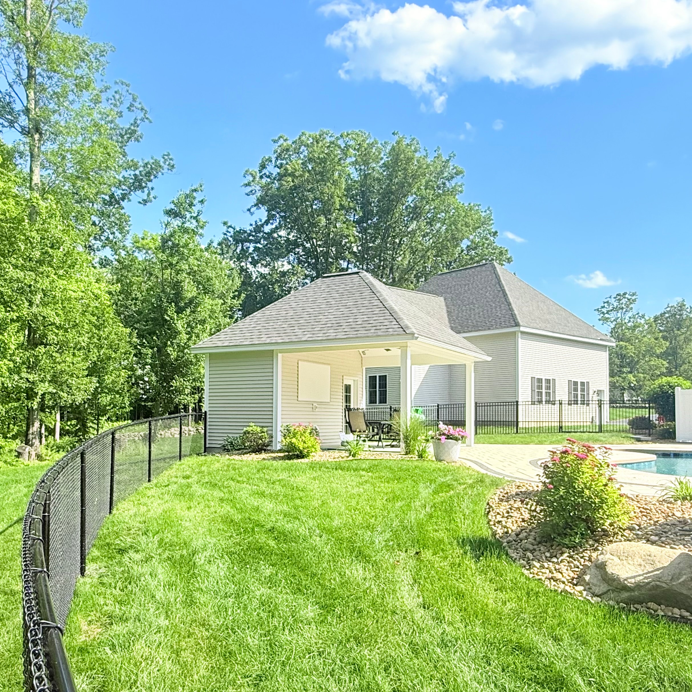 Black chain link fence around residential pool and backyard by Ultra Fence LLC